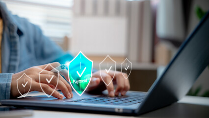 Woman using stylus and laptop with payment security icon on digital screen. Concept of secure...