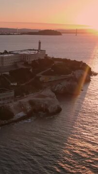 Alcatraz Island, USA, at sunset. The former prison is now a popular tourist destination, offering tours and historical insights. The sun sets over the bay.