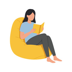 Woman relaxing in yellow beanbag chair reading a book comfortable home leisure activity