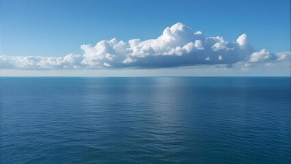 Vast expanse of calm, blue ocean water under a bright, puffy cloud formation.