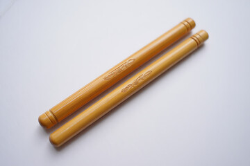 Two natural miswak sticks used for oral hygiene and teeth cleaning on a plain white background