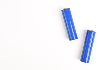 Two blue AA size batteries isolated on white backgraound