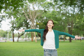 Fototapeta premium A front view of a cute girl making a heart shape with her hands. (Expression)