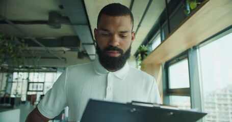 A Professional Individual Reviewing Important Documents in a Modern Office Setting
