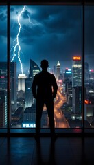 Man silhouette looking at lightning storm over city skyline from office window view