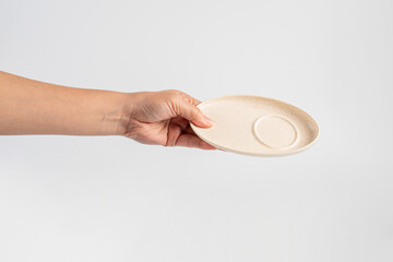 Oval white plate in hand on white background