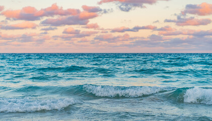 Obraz premium Skyscape with sea horizon. Calm horizon view at sea sunrise. Romantic summer vacation sunrise on seascape. Sea horizon view. Cloudy sky and seascape at summer vacation. Sea waves