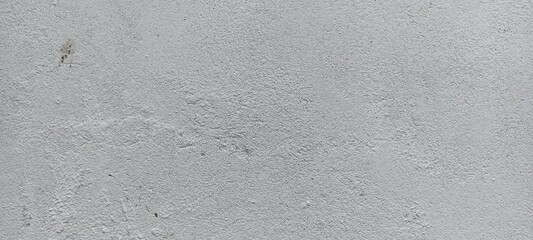 Light Grey Stucco Wall Texture. Subtle light grey stucco wall texture with fine grain and minimal stains, ideal for use in design backgrounds and architectural mockups