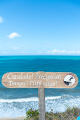 Warning sign on cliff edge viewpoint at Pipa ecological reserve Brazil