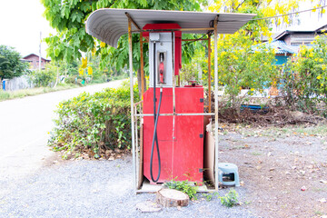 Old small gas pumps with benzene at gas station. Installed in rural areas in Thailand for refueling vehicles traveling on the road.