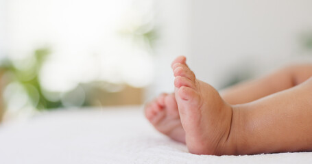 Baby, newborn and feet on bed with sleeping for growth development, security and wellness in home. Space, barefoot and toes of infant in bedroom for resting, morning nap and innocent youth in nursery