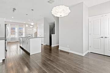 Large open kitchen with a white island and a white refrigerator