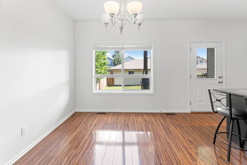 Large open living room with a window and a door