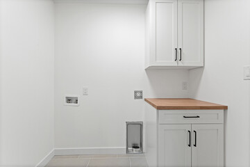 White bathroom with a wooden counter and a sink