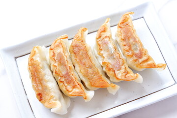 焼き餃子 - 外がパリパリ、中がジューシー、焦げ目がおいしそうな焼きギョウザ
