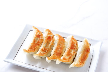 焼き餃子 - 外がパリパリ、中がジューシー、焦げ目がおいしそうな焼きギョウザ
