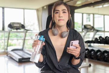 Confident Asian non binary transgender woman in gym training for healthy fitness lifestyle