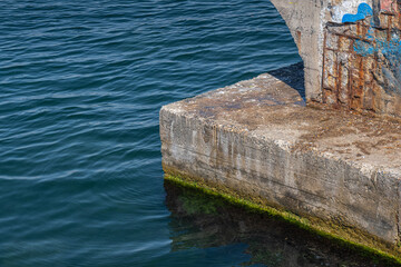abandoned, rotten, old and worn-out concrete pier.