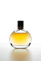 Round glass perfume bottle with golden liquid and black cap image