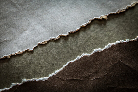 Layers of torn paper reveal textures, colors, and depth &mdash; a visual metaphor for contrast, complexity, and creativity."