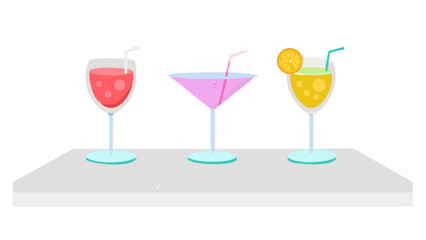 Three colorful cocktails with straws and orange slice sitting on a white surface in a bright setting