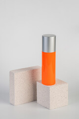 Skin care or sunscreen cosmetic with stylish props on white background.