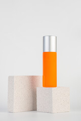 Skin care or sunscreen cosmetic with stylish props on white background.
