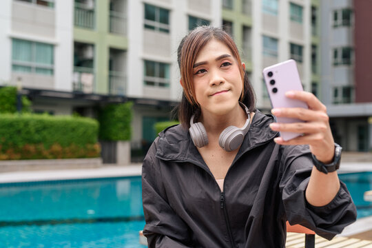 Transgender non binary woman relaxing poolside in healthy lifestyle concept during summer - Powered by Adobe