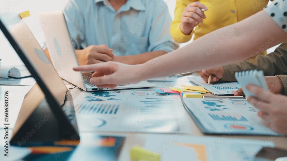 Poster a diverse group of professionals collaborates in a modern office, analyzing graphs and discussing st