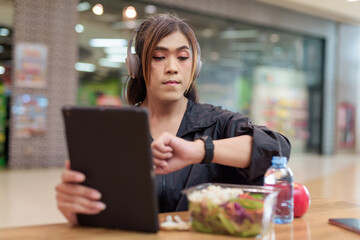 Transgender non binary woman eating healthy salad in restaurant