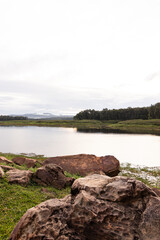 Wide natural view, with a stone front, overlooking the river, forest and mountains.