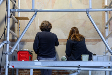 View of two people working on the restoration of the frescoes at the Camposanto (Monumental...