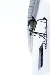ronda,malaga,spain Traditional andalusian architecture featuring a vintage lamp hanging on a white...