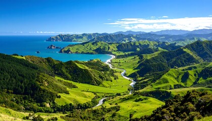 Obraz premium Panoramic view of a lush valley with a winding river flowing to a bay