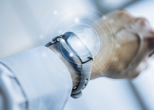 A person wearing a futuristic smartwatch with glowing digital interface