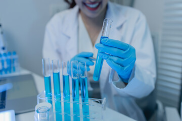 a female chemist is testing various liquid compounds in a lab, a scientist is doing research on the...