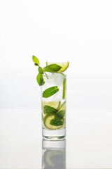 Mojito cocktail with lime and mint in highball glass on white background
