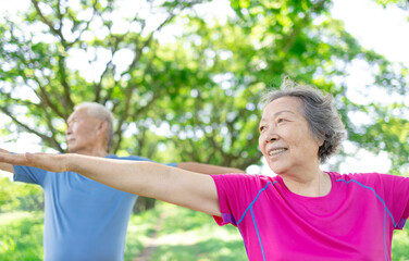 Happy asian senior couple exercising in the park.