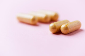 Vitamin B complex capsules on bright paper background. Soft focus. Close up. Copy space. 