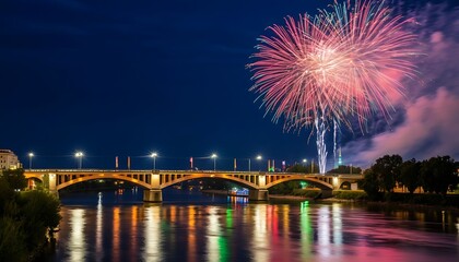 Fototapeta premium Fireworks exploding over the Nibelungen Bridge in Linz, Austria during a summer night celebration