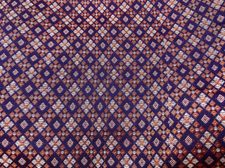 ChatGPT said:
An intricate geometric checkered pattern is brocade woven into luxurious purple silk,...