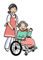 介護士と車椅子のシニア女性