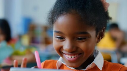 Smiling girl using tablet in classroom, learning through digital technology – education and innovation. - Powered by Adobe