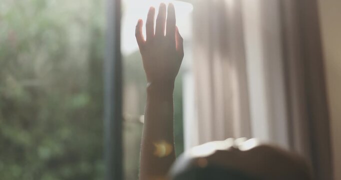 Hands, basking or person with sungazing in bedroom for vitamin D, playful interaction or imagination. Relax, woman or comfortable in sunlight in house for weekend break, peaceful morning or serotonin