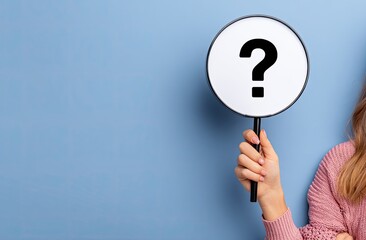 A hand holds a circular sign with a question mark