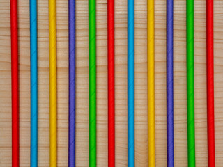 Background with colorful drinking straws. Wooden background with colorful lines. Ecologically friendly colorful straws for party  