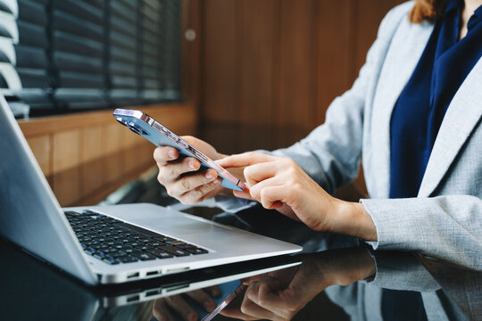 Businesswoman hand working digital marketing media in virtual screen with mobile phone and modern compute