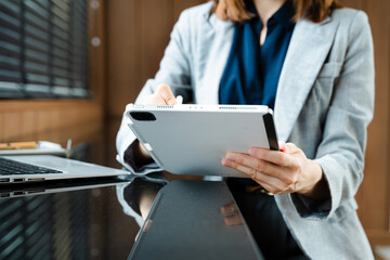 Businesswoman hand working digital marketing media in virtual screen with mobile phone and modern...