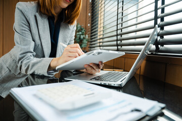 Businesswoman hand working digital marketing media in virtual screen with mobile phone and modern...