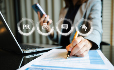 PR, Public relations concept. hands using laptop and tablet with public relations icon for...